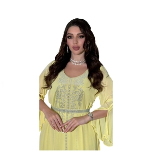 Detail of yellow chiffon dress featuring silver rhinestone embroidery and flared cuffs