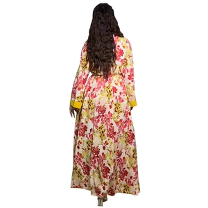 Detail of floral maxi dress featuring long sleeves with vibrant yellow cuff accents