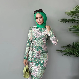 Detail of floral paisley print dress with waist tie and matching long sleeves
