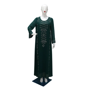 Detailed view of silver geometric rhinestone patterns on a dark green long-sleeved robe