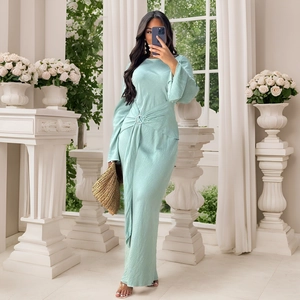 Detail of elegant mint blue silk maxi dress with waist metal buckle and cross pleats