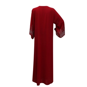 Detail of silver geometric sequins on the sleeves of a long red chiffon kaftan dress