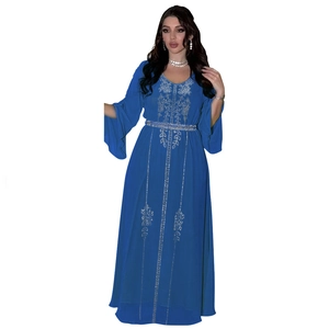 Detail of silver rhinestone embroidery and sequin floral patterns on a royal blue chiffon abaya
