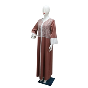 Detailed view of terracota satin dress with silver sequins and white contrast trim