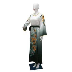 Detail of floral printed maxi dress with gradient shades and rhinestones on long sleeves