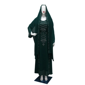 Close-up of silver rhinestones and geometric patterns on dark green long kaftan dress
