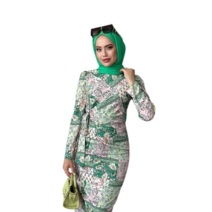 Detail of green paisley long sleeve dress with waist tie and matching hijab accessory