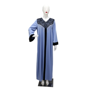 Detail of light blue velvet abaya featuring black lace V-neck and sparkling rhinestones
