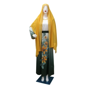 Close-up of yellow chiffon hijab with silver sequins and floral printed gradient dress