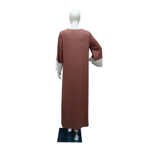 Detail view of brown satin Abaya with white contrast stitching on long sleeves and cuffs