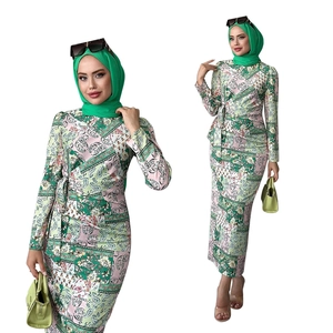 Detail of green and pink paisley print muslim dress with matching hijab and waist tie