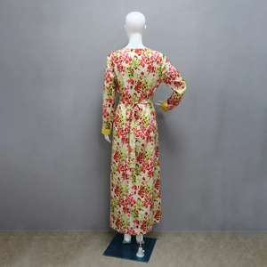 Rear view of floral long dress showing back waist tie and yellow elastic cuffs
