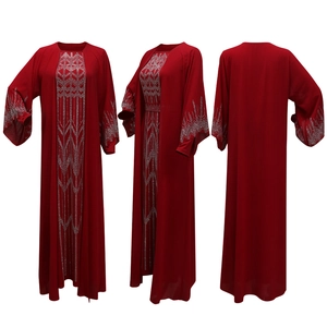 Macro view of silver rhinestone geometric patterns on deep red chiffon abaya dress