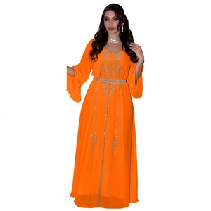 Detail of orange chiffon kaftan dress with intricate silver rhinestone floral patterns