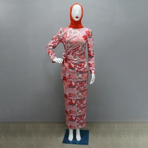 Detail of floral paisley print dress with side knot and matching orange hijab