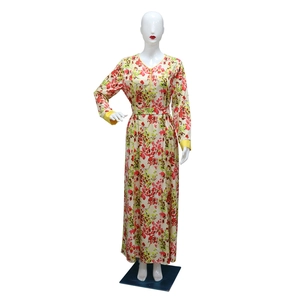 Detail of floral maxi dress showing V-neck with yellow trim and button decoration