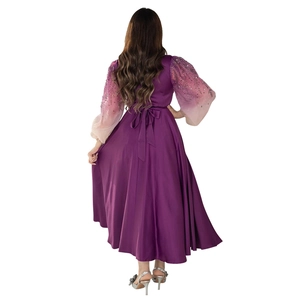 Detail of purple jalabiya dress featuring gradient sequin sleeves and a lace-up back design