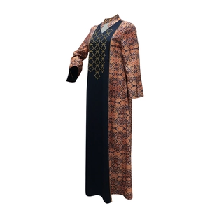 Close-up of geometric pattern and rhinestone accents on ethnic long robe dress