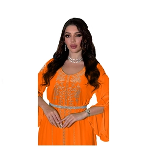Detail of orange kaftan dress featuring silver rhinestones and split flare sleeves