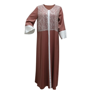Detail of silver branch sequin embroidery and contrast white panels on a satin kaftan