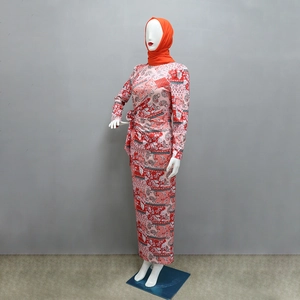 Detail view of paisley floral long sleeve Muslim dress with side tie and orange hijab