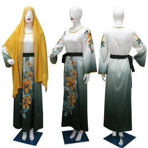Detail of Muslim Abaya showing gradient green color with yellow floral prints and rhinestones