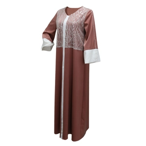 Detail of satin abaya featuring sequin patchwork and elegant white contrast sleeve cuffs