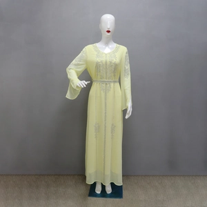 Close-up of yellow chiffon kaftan dress with silver rhinestone embroidery and belt