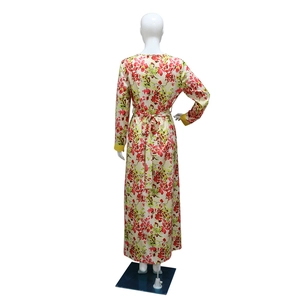Back view of a long-sleeved floral maxi dress with red flower print and yellow cuffs