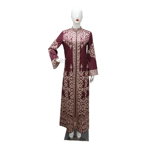 Detail of burgundy jalabiya dress featuring intricate white baroque ethnic patterns