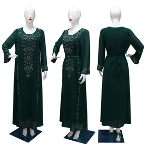 Detailed view of dark green long-sleeved robe with intricate silver rhinestone patterns