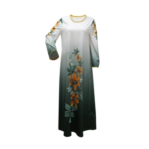 Close-up of elegant gradient floral dress with yellow wave trim and rhinestone details