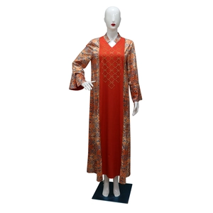 Detail of red color block with gold studs and blue geometric prints on ethnic kaftan