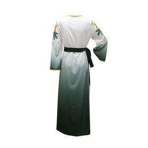 Detail of ombre robe dress with floral patterns and yellow lace trim on neckline