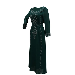 Detail of dark green Muslim abaya dress featuring silver rhinestone geometric patterns