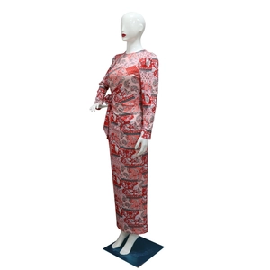 Detail view of pink and red paisley print long dress with knotted waist and floral pattern