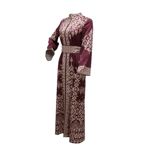 Detailed pattern view on a burgundy jalabiya abaya dress with white ethnic embroidery