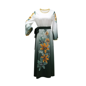Detailed view of floral print and wave trim on this gradient green long abaya dress