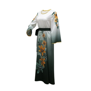 Macro detail of gradient long dress with rhinestone lily patterns and golden wavy neckline