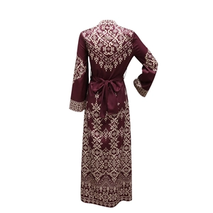 Detail view of ethnic jalabiya back with burgundy floral print and bow tie waist ribbon