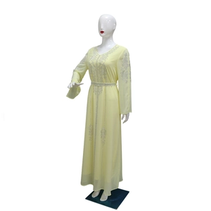 Detail of light yellow chiffon maxi dress with silver rhinestones and beaded belt