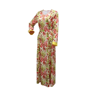 Detailed view of floral maxi dress with V-neckline and bright yellow contrast cuffs