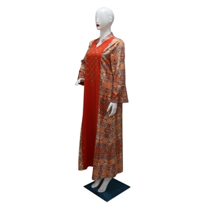 Detailed gold bead embroidery on red satin V-neckline of ethnic kaftan dress