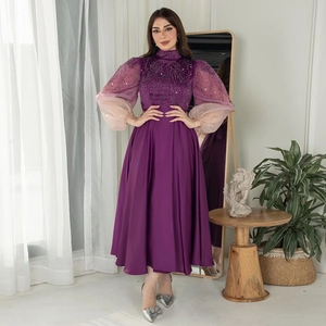 Detail of beaded embroidery on high-neck purple satin jalabiya gown with gradient puff sleeves