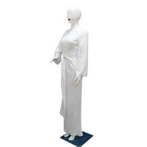 Detail of elegant white long-sleeve maxi dress with waist metal ring and side tie detail