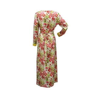 Detailed back view of a floral maxi dress with yellow cuffs and a matching waist tie