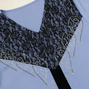 Detail of V-neckline with black rose lace stitching and silver rhinestones on blue dress