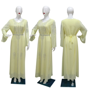 Detail of light yellow chiffon dress with silver rhinestones on collar and waist