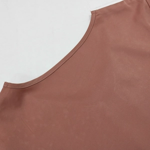 Close-up of smooth terracotta satin neckline detail with high-quality stitching on dress