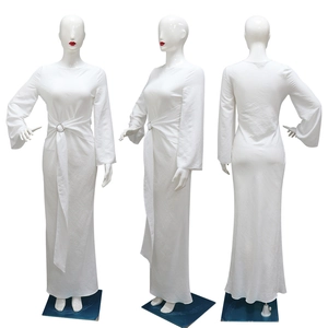 Detail of elegant white maxi dress featuring metal ring waist and flared sleeves